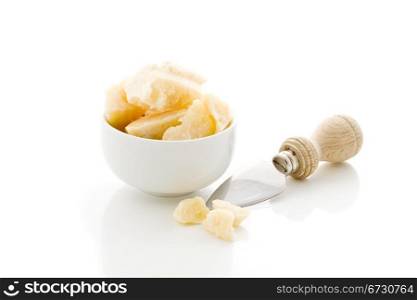 italian parmesan inside a bowl with knife on white isolated background