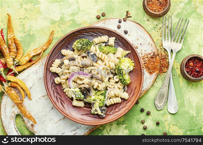 Italian pasta farfalle with broccoli and mushrooms.Italian food. Broccoli pasta in plate