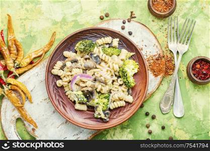 Italian pasta farfalle with broccoli and mushrooms.Italian food. Broccoli pasta in plate