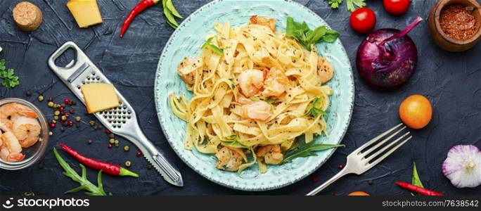 Italian pasta fettuccine with shrimp on a plate. Spaghetti pasta with shrimps