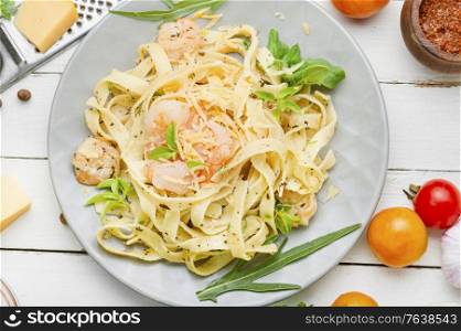 Italian pasta fettuccine with shrimp on a plate. Spaghetti pasta with shrimps