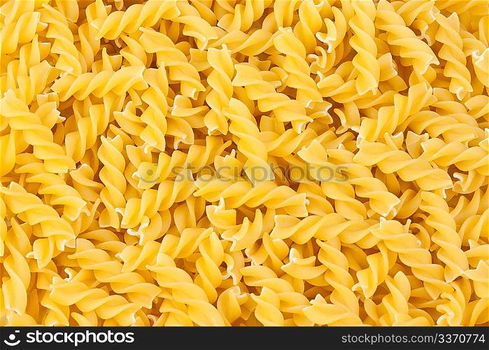 italian pasta fusilli yellow background