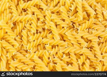 italian pasta fusilli yellow background