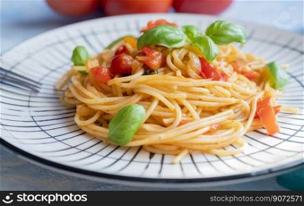 Italian pasta in a restaurant with tomato sauce and basil
