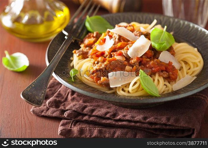 italian pasta spaghetti bolognese with basil on rustic table