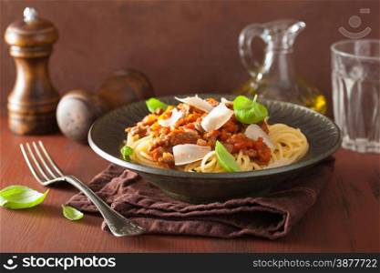 italian pasta spaghetti bolognese with basil on rustic table