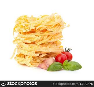 Italian pasta tagliatelle nest and cherry tomato isolated on white background
