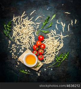 Italian pasta with tasty ingredients for cooking, top view.