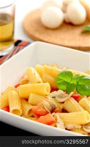 Italian pasta with tomatoes, mozzarella and mushrooms.