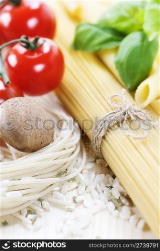 Italian Pasta with tomatoes, mushrooms, rice and basil on a white background