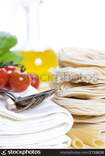Italian Pasta with tomatoes, olive oil and basil on a white background