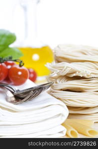 Italian Pasta with tomatoes, olive oil and basil on a white background