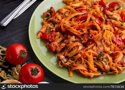 italian pasta with tomatos and herbs on dark wooden table. italian pasta recipe. close up