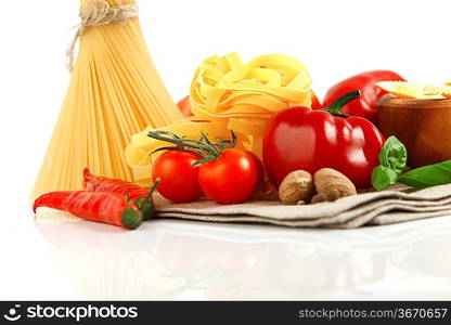 Italian Pasta with vegetables in wooden plate isolated on white.