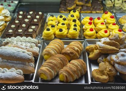 Italian pastry shop. Showcase on pastry shop. Cream and sweets.