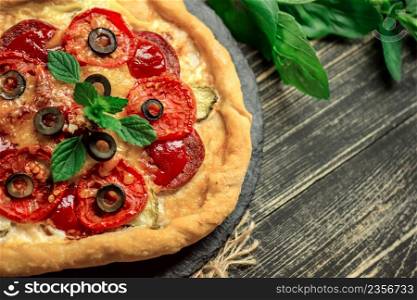 Italian pizza and pizza ingredients served on wooden background. Pizza seafood on a wooden table. . Pizza with seafood and tomato