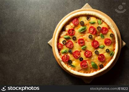 italian pizza at black table background