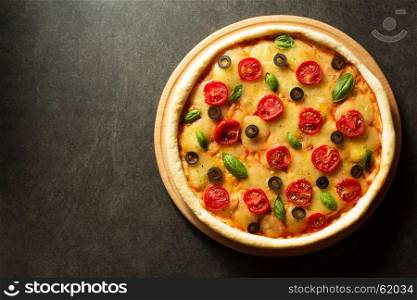 italian pizza at black table background
