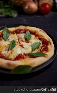 Italian pizza Margherita with basil leaves . Italian pizza Margherita