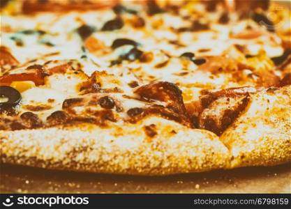 Italian Pizza With Mozzarella, Prosciutto, Tomatoes And Olives