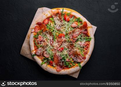 Italian pizza with prosciutto, arugula and tomatoes
