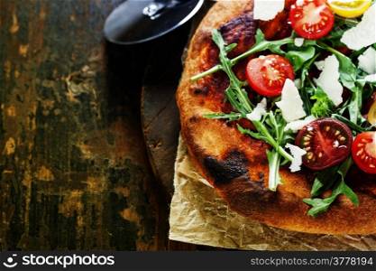Italian pizza with rucola and cherry-tomatoes