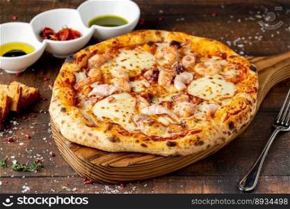 Italian pizza with shrimp and mozzarella on a cutting board