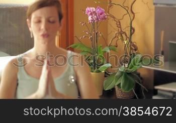 Italian pregnant woman doing yoga at home. Rack focus