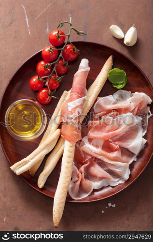 italian prosciutto ham grissini bread sticks tomato olive oil