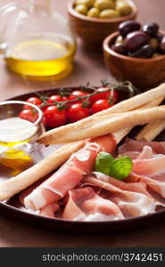 italian prosciutto ham grissini bread sticks tomato olive oil