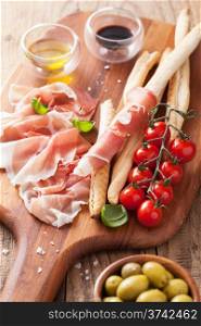 italian prosciutto ham grissini bread sticks tomato olive oil