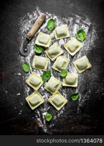 Italian Ravioli raw. On dark rustic background. Italian Ravioli raw.