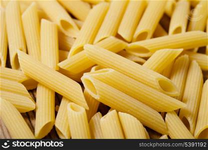 Italian raw pasta - penne background closeup