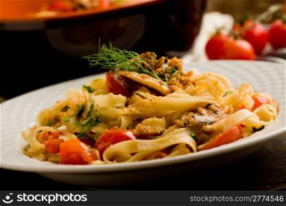 Italian regional dish made of pasta with sardines on wooden table
