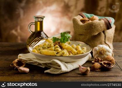 Italian regional dish made of pasta with walnut pesto on wooden table