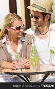Italian restaurant terrace elegant couple sitting drink water summer day