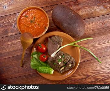 Italian rustic dinner - tomato soup or Pappa al Pomodoro and roasted beef and vegetables with bread ,farm-style