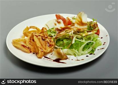 Italian salad with fried calamari, parmesan