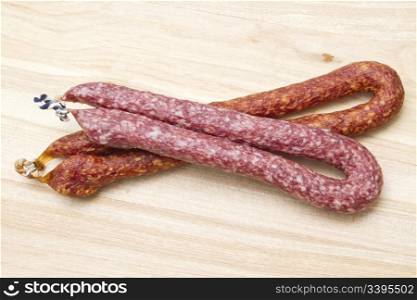 Italian salami sausgages closeupp on wood background
