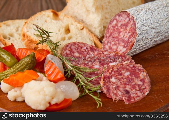 Italian salami with bread,rosemary and pickles