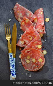 Italian salami with nuts on ardesia plate
