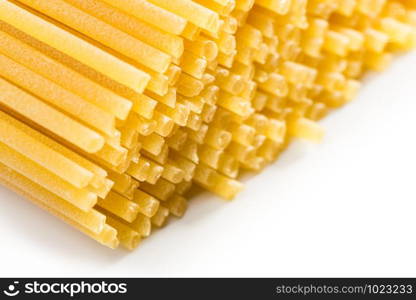 Italian spaghetti extruded through bronze, on white background