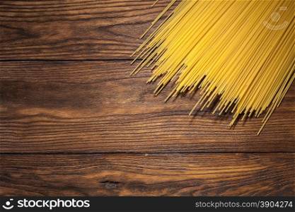 italian spaghetti on wooden background. italian spaghetti on wooden background. Top view