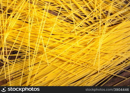 italian spaghetti on wooden background. italian spaghetti on wooden background. Top view