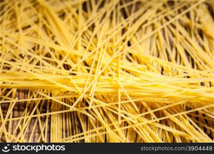 italian spaghetti on wooden background. Top view. italian spaghetti on wooden background