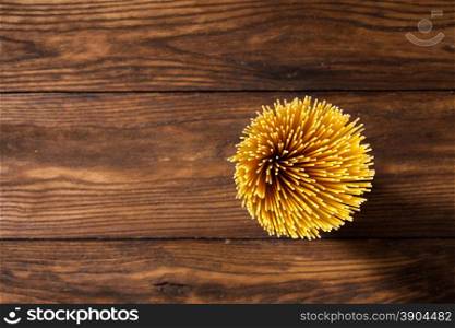 italian spaghetti on wooden background. Top view. italian spaghetti on wooden background