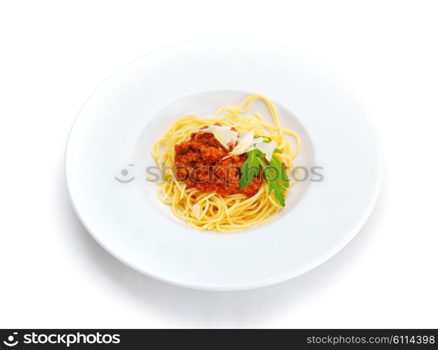 Italian spaghetti topped with bolognaise, or bolognese, sauce with tomatoes, meat and cheese on a plain white plate