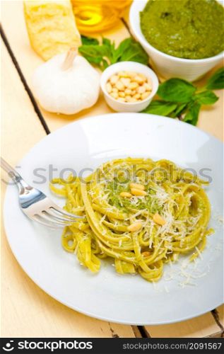 Italian traditional basil pesto pasta ingredients parmesan cheese pine nuts extra virgin olive oil garlic on a rustic table