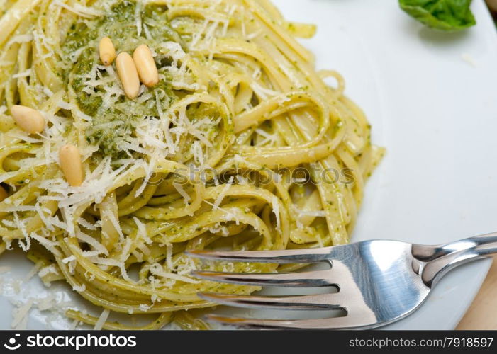 Italian traditional basil pesto pasta ingredients parmesan cheese pine nuts extra virgin olive oil garlic on a rustic table