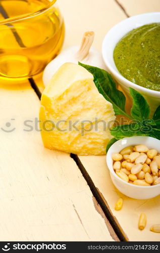 Italian traditional basil pesto sauce ingredients on a rustic table